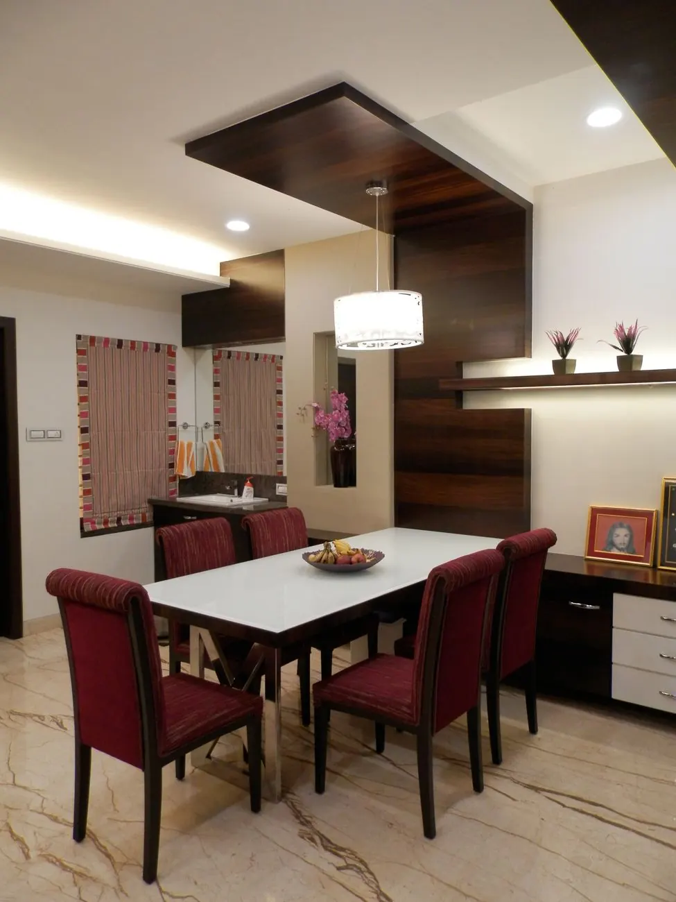 Dining area under a dropped veneer ceiling feature with cove lighting