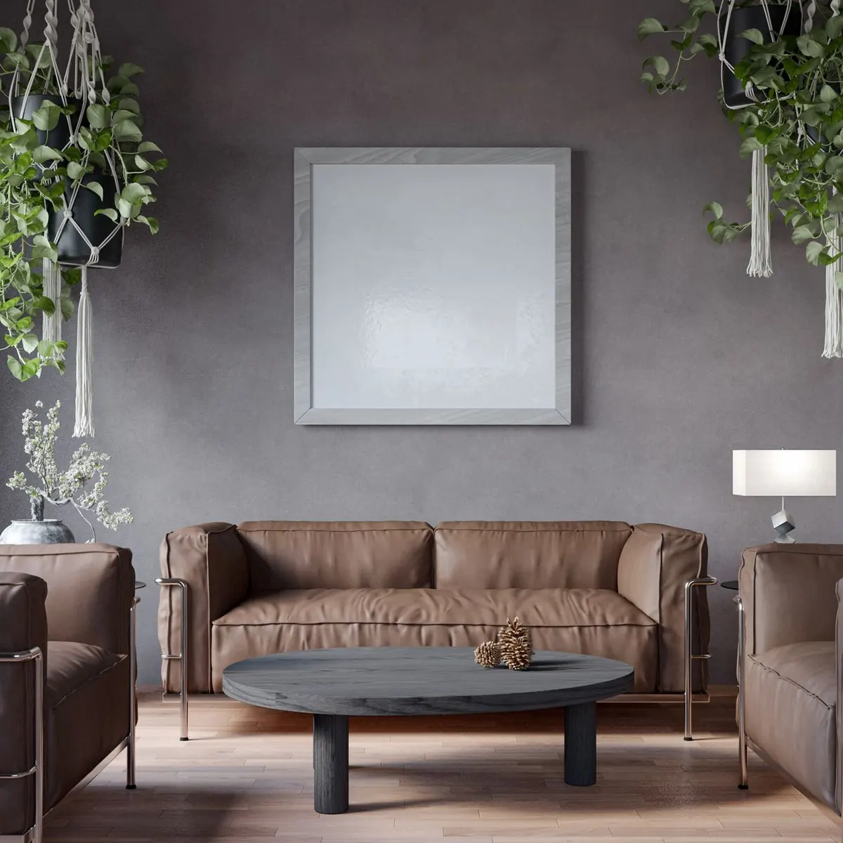 Leather sofa against a textured grey wall with hanging plants